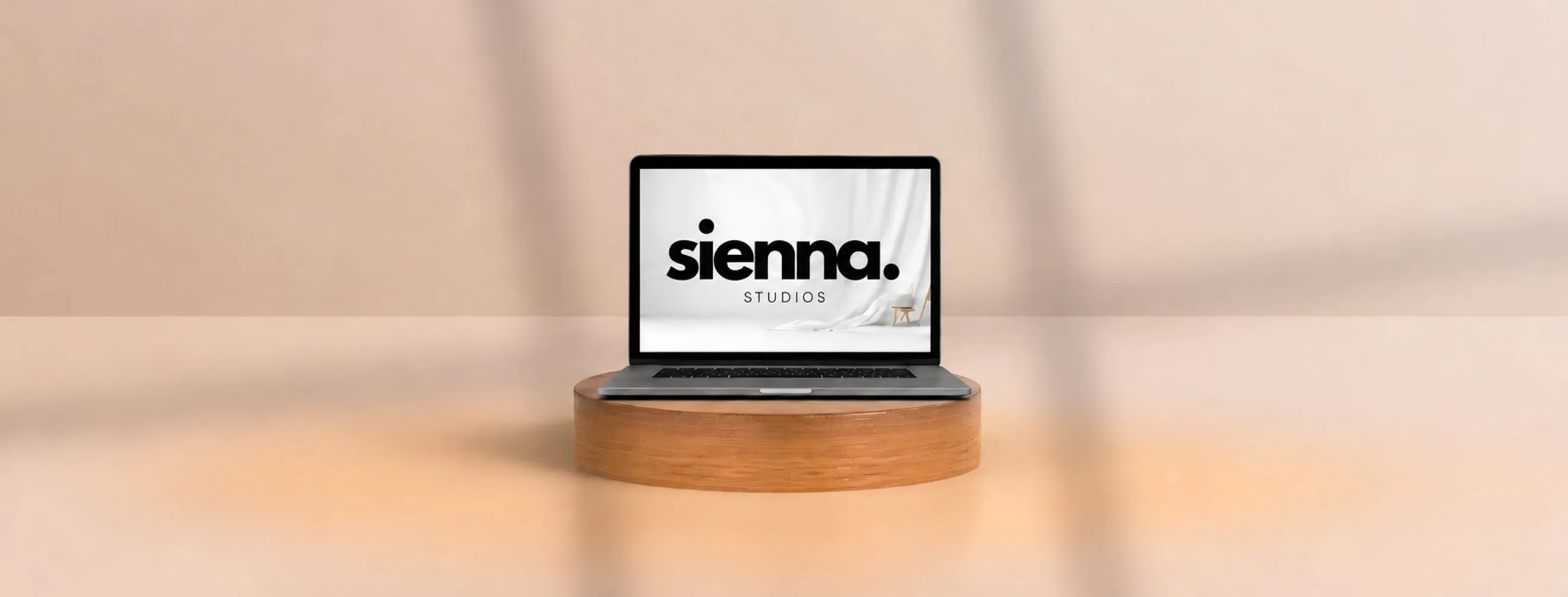 A laptop on a wooden pedestal showing an example restaurant website